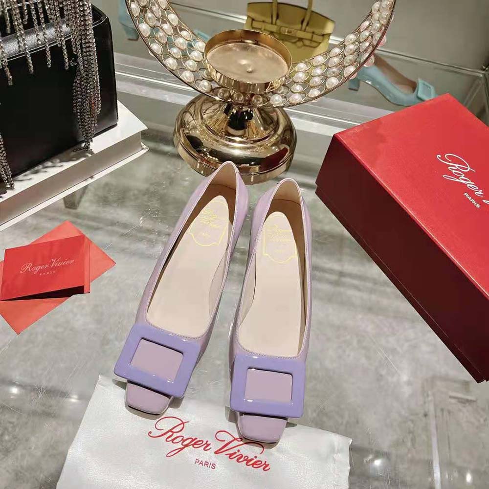 Close-up of purple patent leather and signature buckle on Belle Vivier Pumps