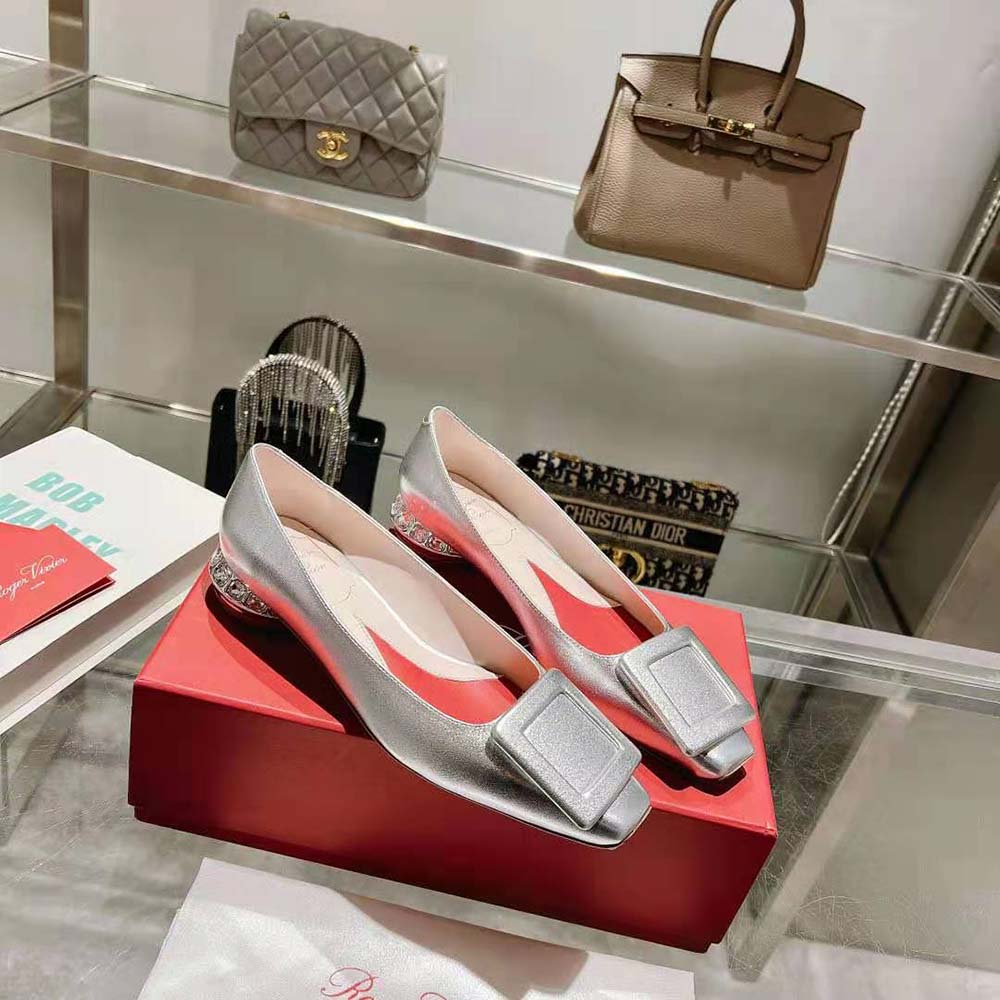 Overhead view showing silver nappa leather and heel details of Roger Vivier ballerinas