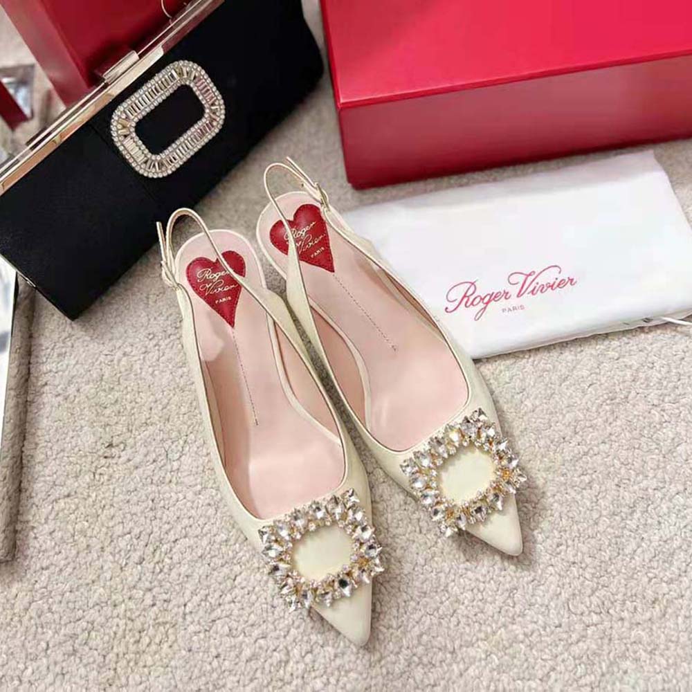 Close-up of sparkling strass buckle on Roger Vivier white slingback pumps