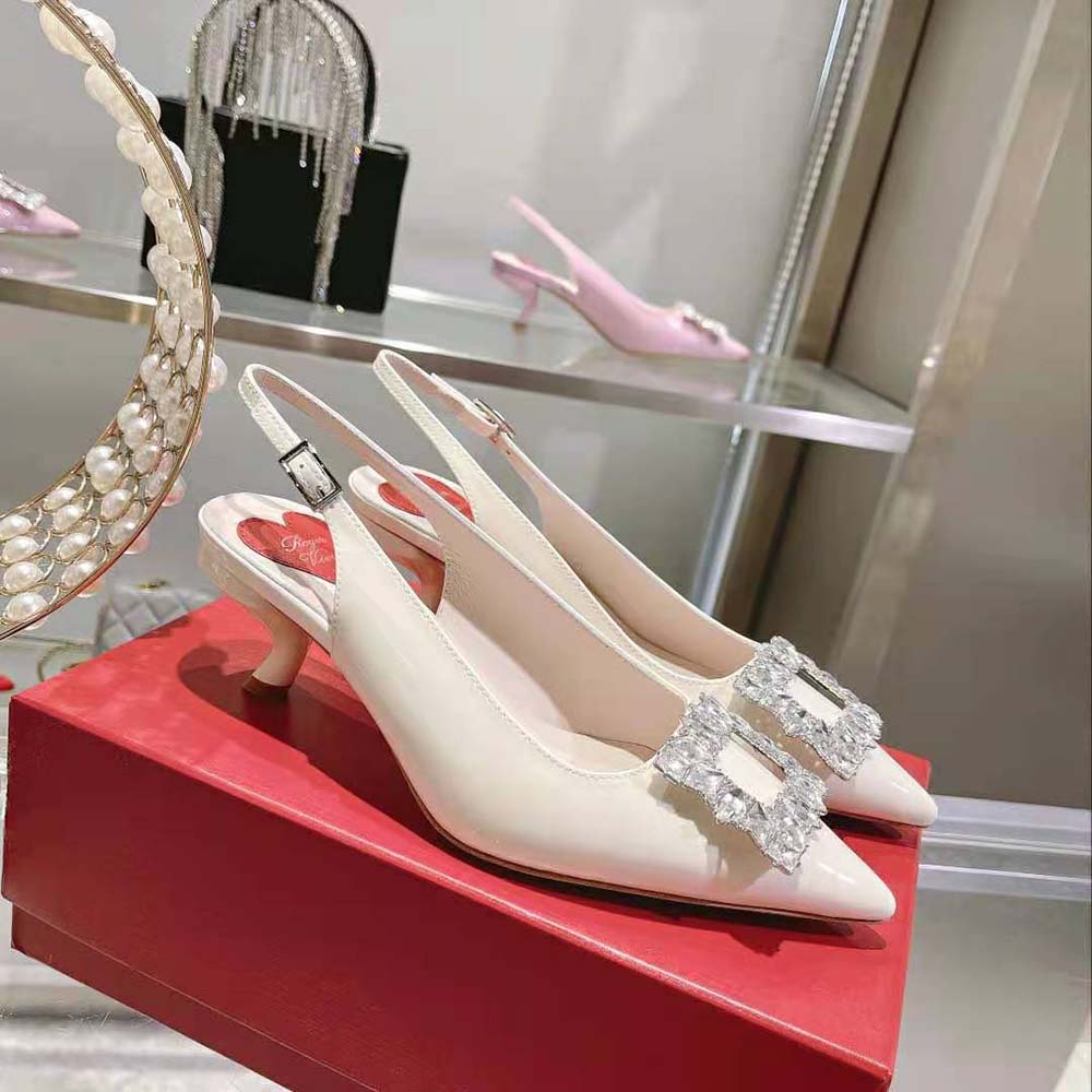 Top angle showing sleek white patent leather and slingback strap of Roger Vivier pumps