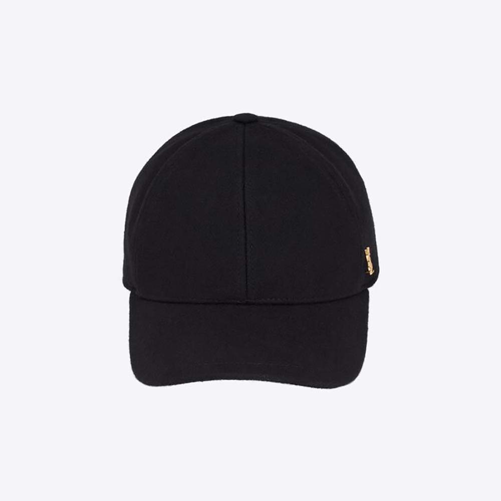 Close-up of YSL Cassandre metal logo on black felt cap