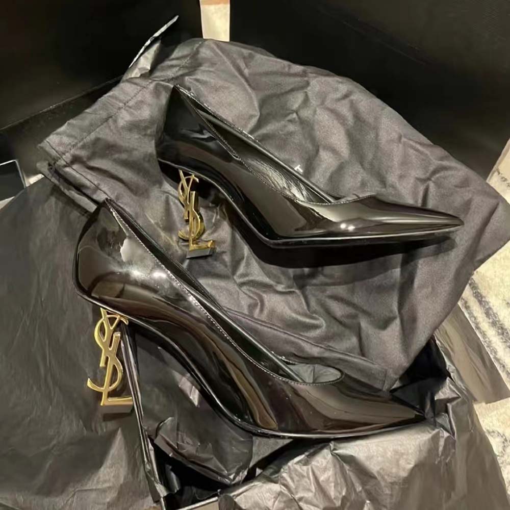Close-up of glossy patent leather and gold hardware on Opyum Pumps