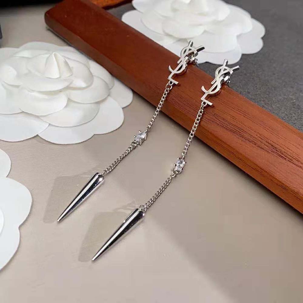 Side profile showing silver spike and rhinestone details on Saint Laurent YSL earrings