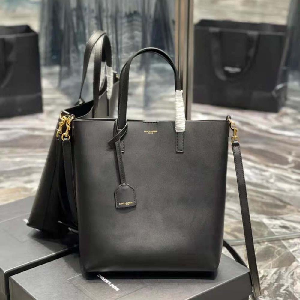 Close-up of gold YSL logo hardware on black leather Saint Laurent Toy bag