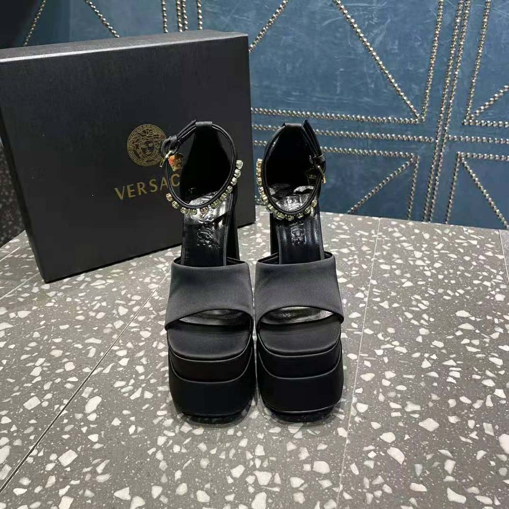 Close-up on gold Medusa hardware of Versace Women Medusa Aevitas Platform Sandals-Black