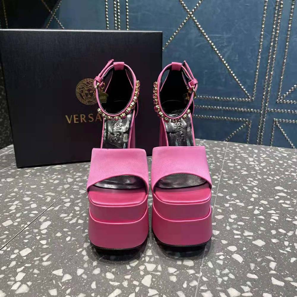 Close-up of gold Medusa emblem on Versace Women Medusa Aevitas Platform Sandals-Pink