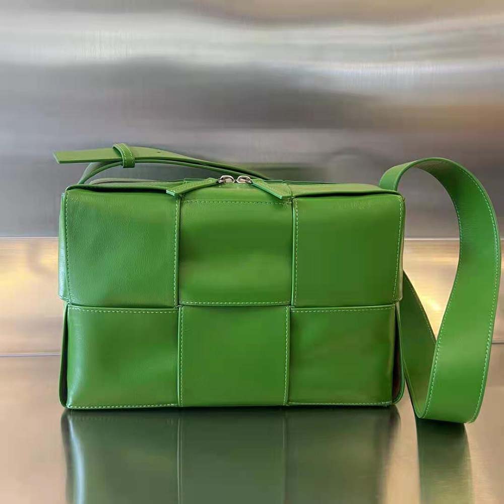 Close-up of intrecciato leather weave on green Bottega Veneta cross-body bag