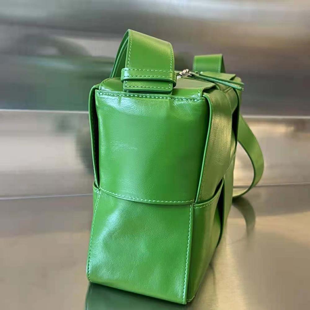 Side angle showing brushed gold hardware on Bottega Veneta Men Intreccio Slouchy Bag