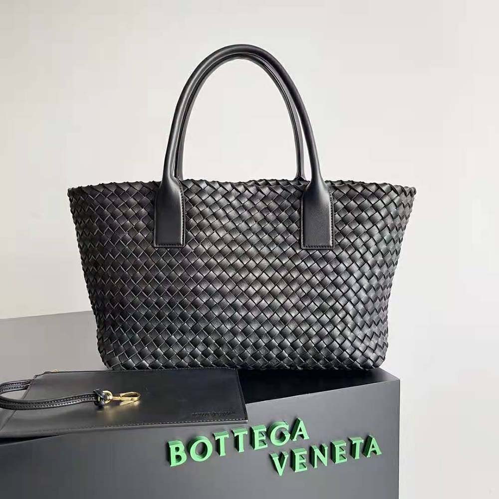 Close-up of intrecciato weave and gold hardware on the black leather tote