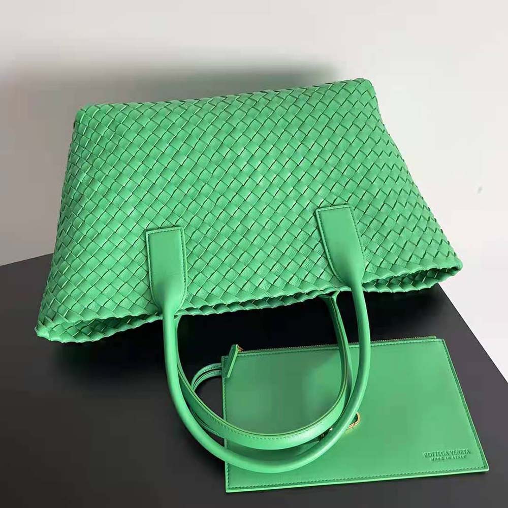Side angle showing matte gold hardware and strap of Bottega Veneta Medium Cabat Tote
