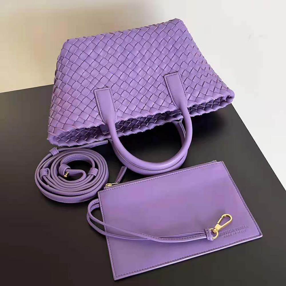 Side angle showing detachable strap and gold hardware on purple tote