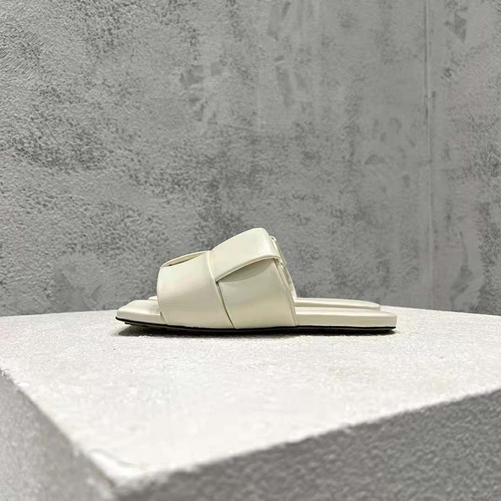 Close-up of padded intreccio leather detail on beige flat mules