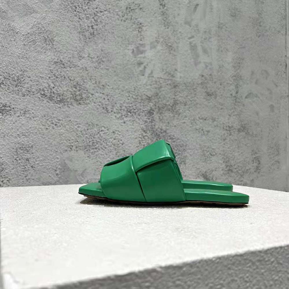 Close-up detail of padded intreccio leather on green Bottega Veneta flat mules