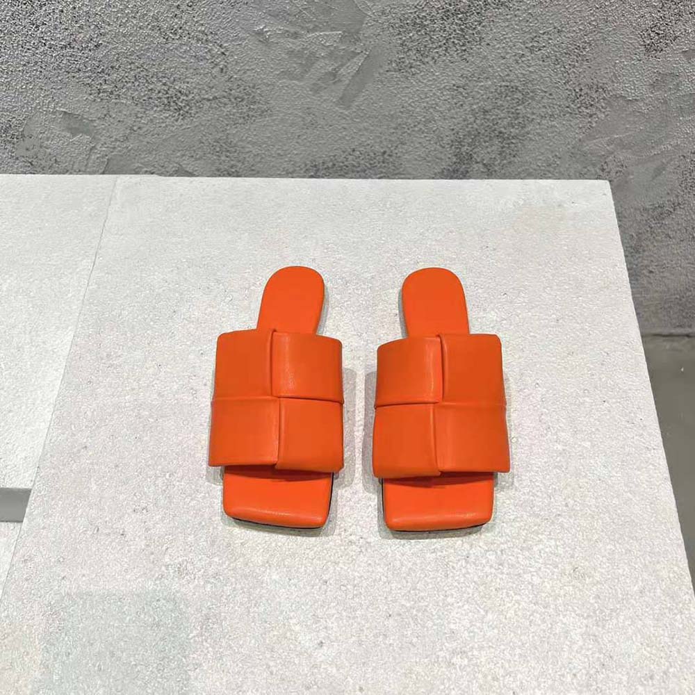 Top angle showing vibrant orange leather and slip-on silhouette