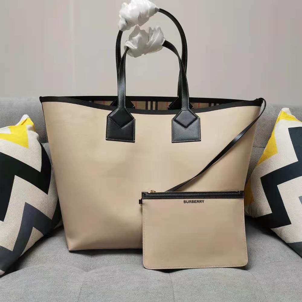 Detail of leather handles and gold hardware on Burberry London tote bag