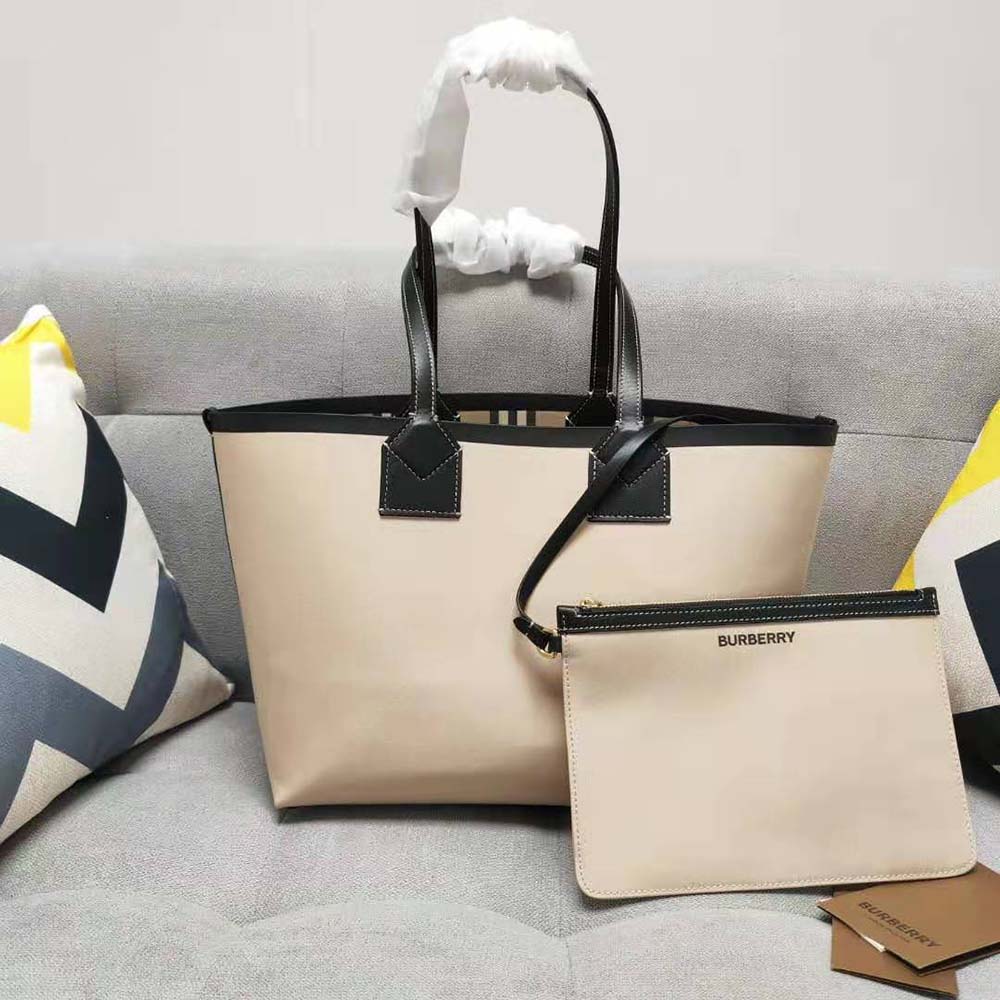 Side angle showing silver hardware and zip closure of Burberry small London tote bag