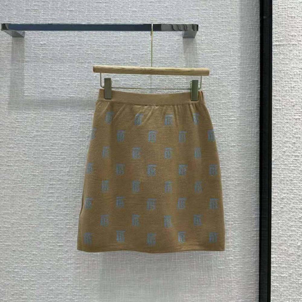 Side angle showing tailored fit of Burberry Women Monogram Mini Skirt