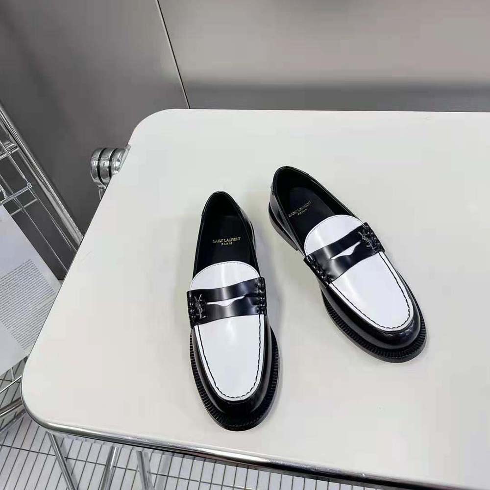 Close-up of glossy patent leather and penny strap detail on Celine slippers