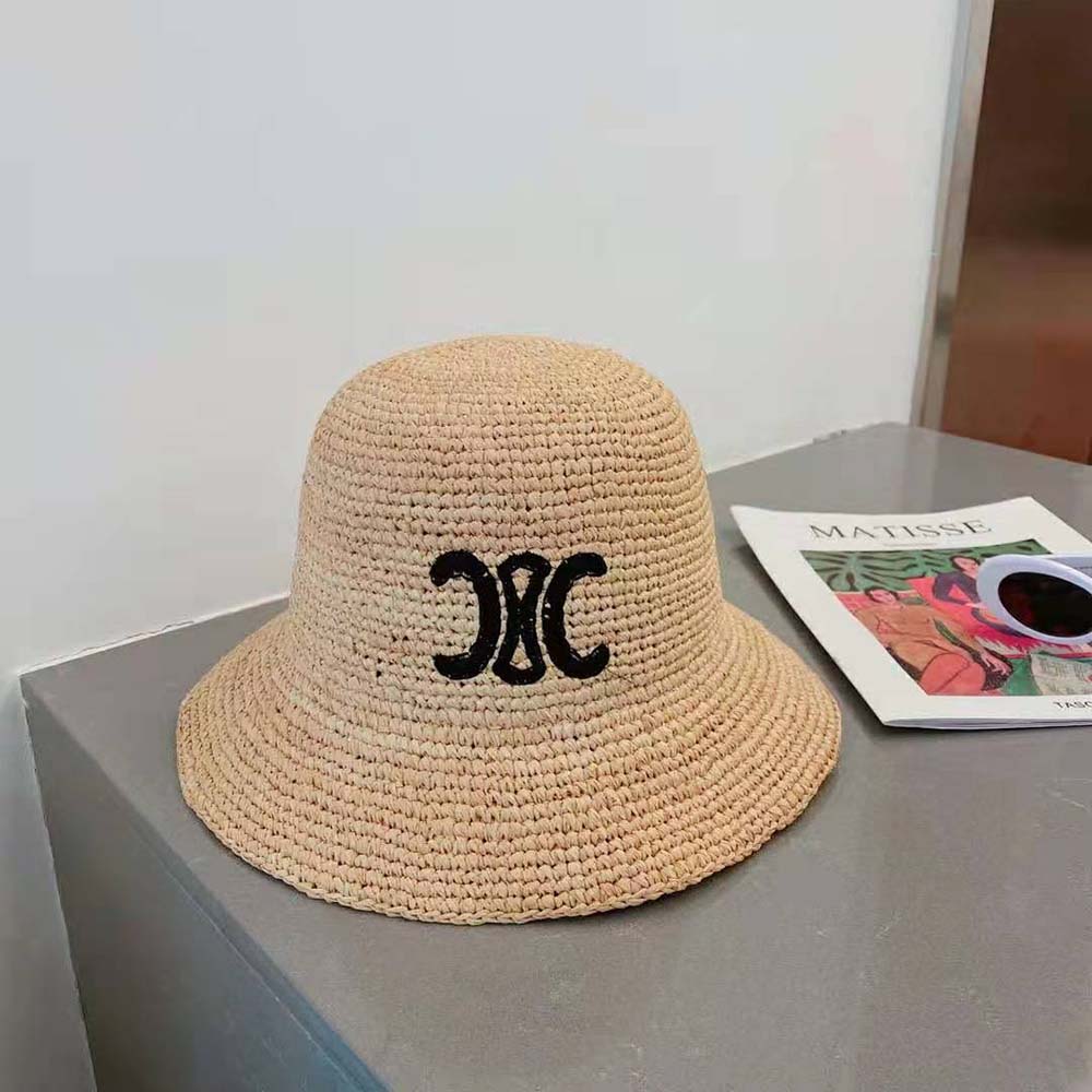 Close-up of gold-tone Triomphe logo on Celine Women Triomphe Hat in Raphia