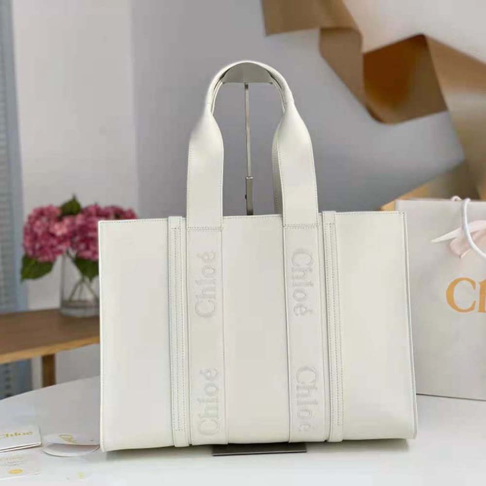 Close-up of embroidered Chloé logo on white leather tote bag