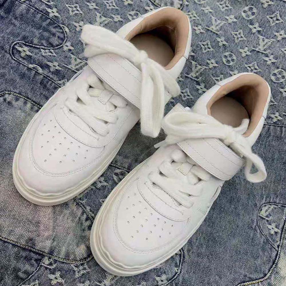 Side view of Chloe Women Lauren Sneaker with Strap-White highlighting gold hardware
