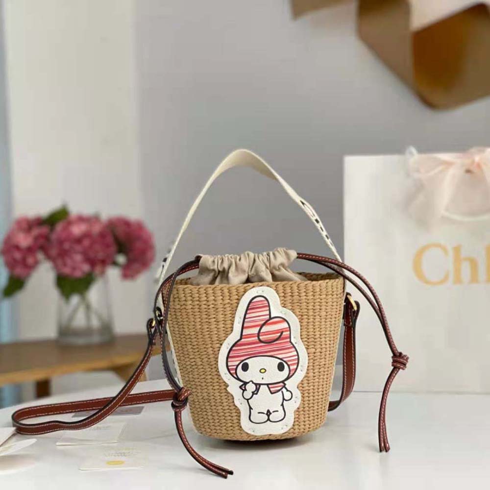 Close-up of wooden handle and gold hardware on Small Woody Basket bag