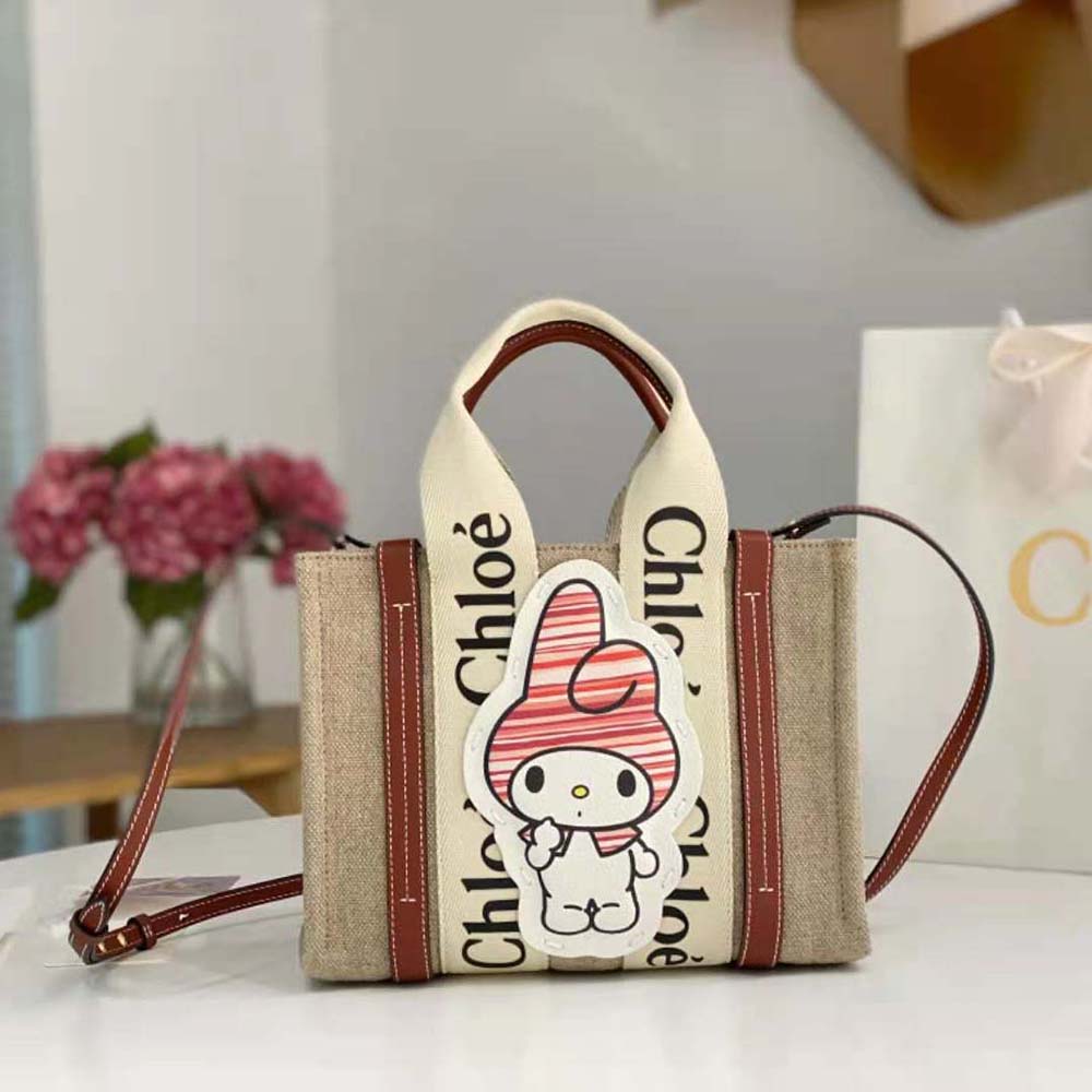 Close-up of woody handle and gold hardware on Chloe Women My Melody tote