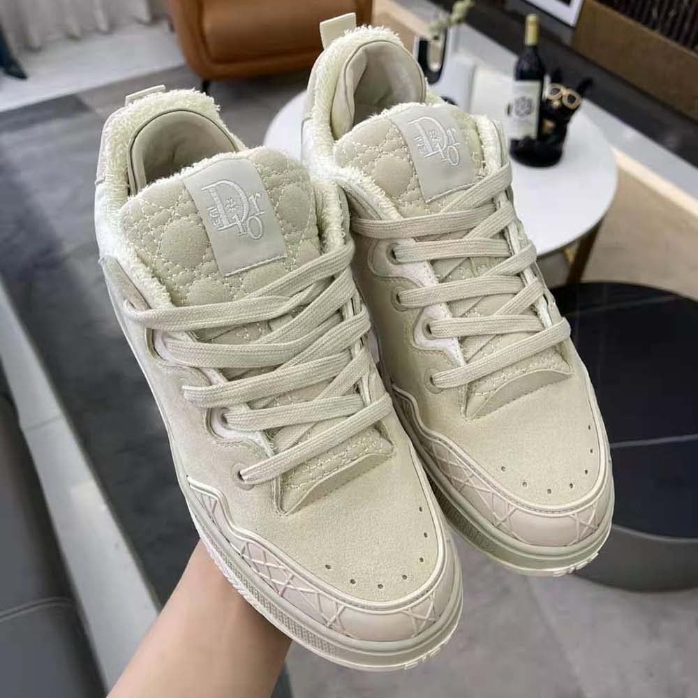 Close-up of embossed Dior logo on white leather tongue of Dior By Erl B9s sneaker