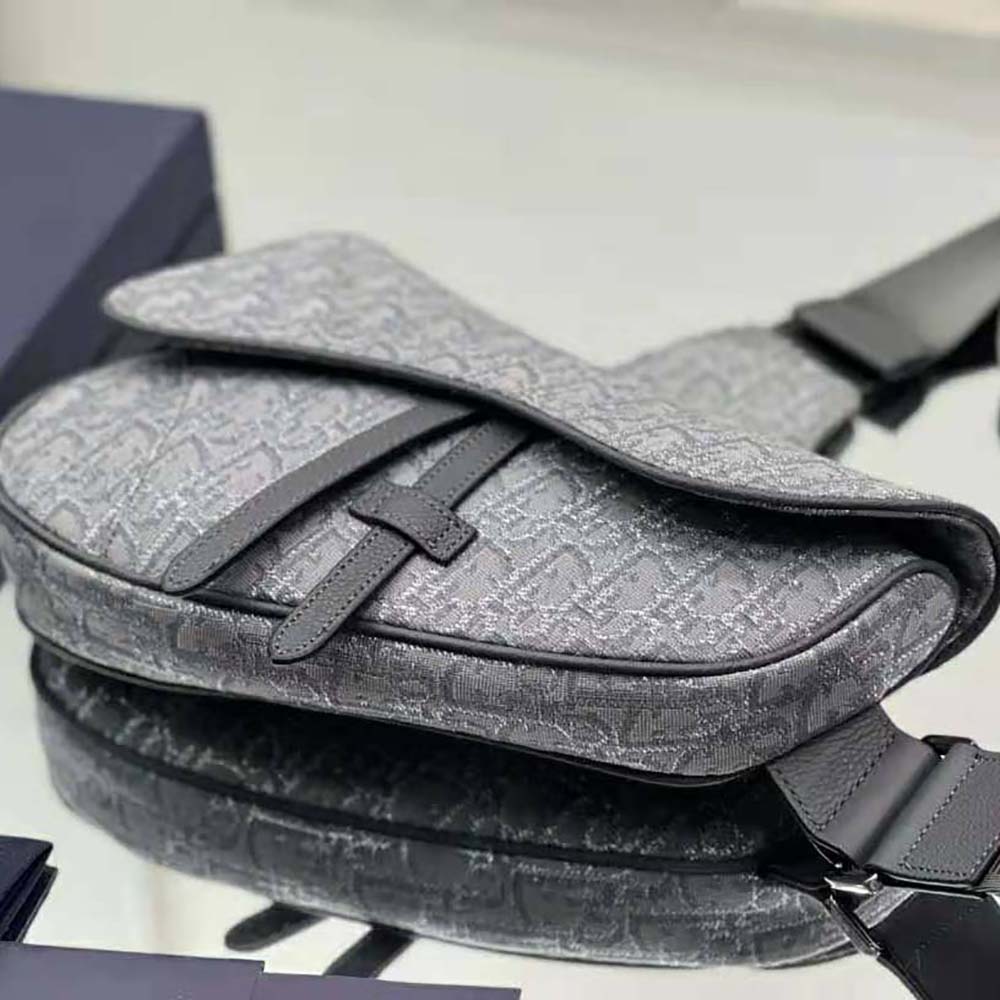 Side profile showing compact silhouette of Dior Men Saddle Bag
