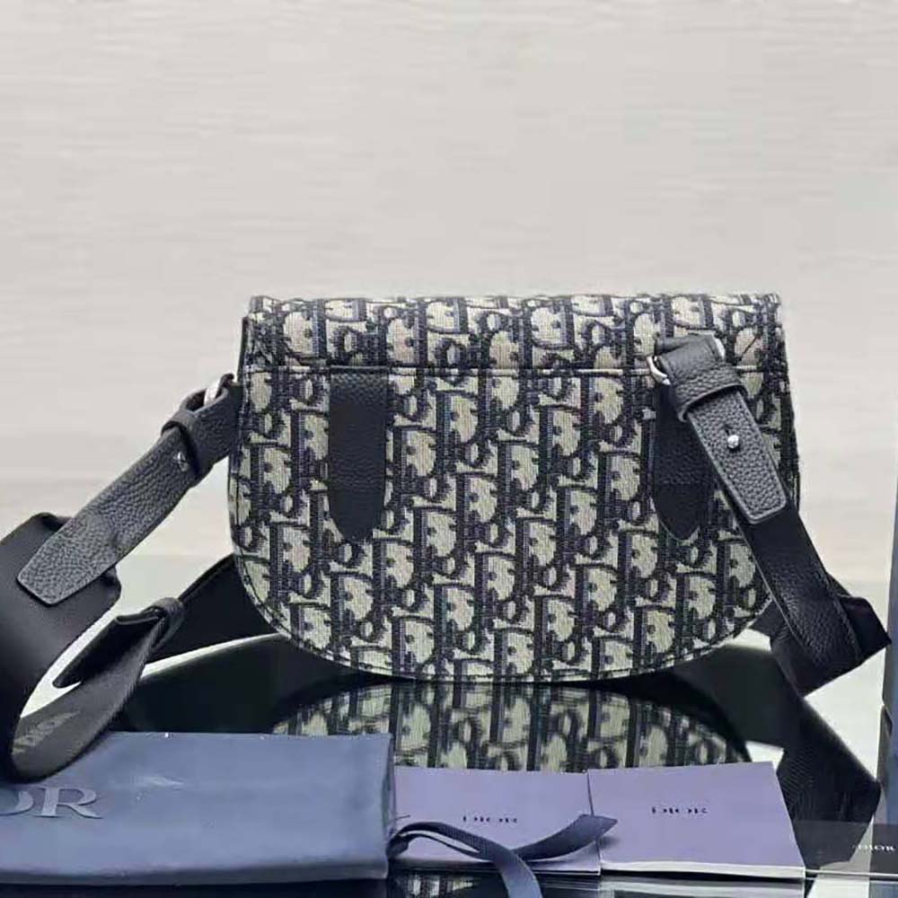 Side angle showing adjustable strap on Dior Men Saddle Pouch beige bag