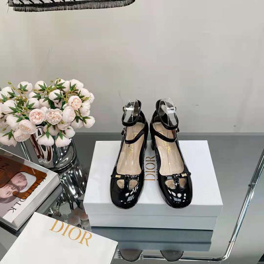 Close-up of glossy patent calfskin and signature Dior hardware detail