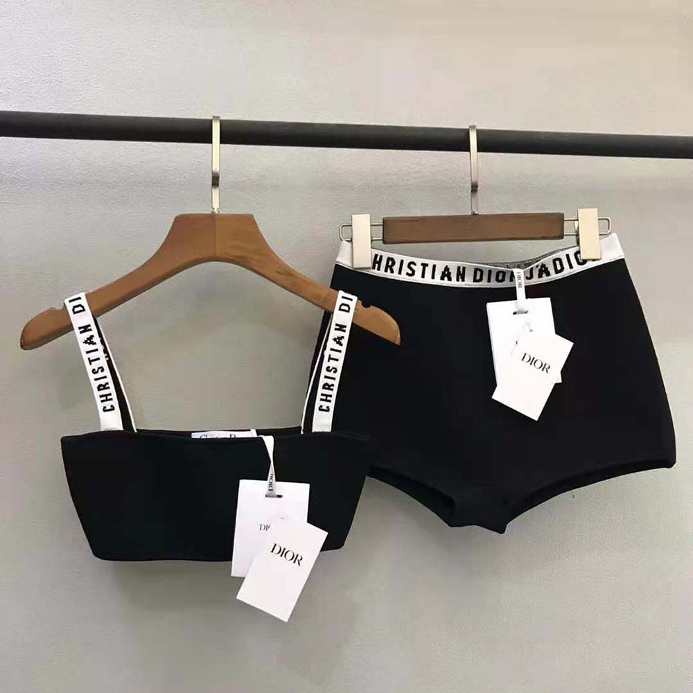 Close-up detail of Dior logo inside waistband on black stretch briefs