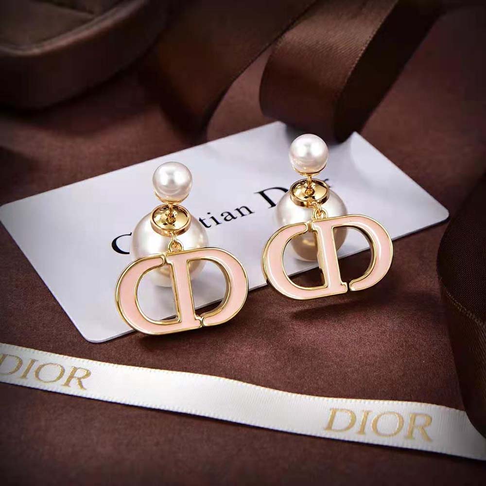 Close-up of white resin pearls and sand pink lacquer on Dior Tribales Earrings