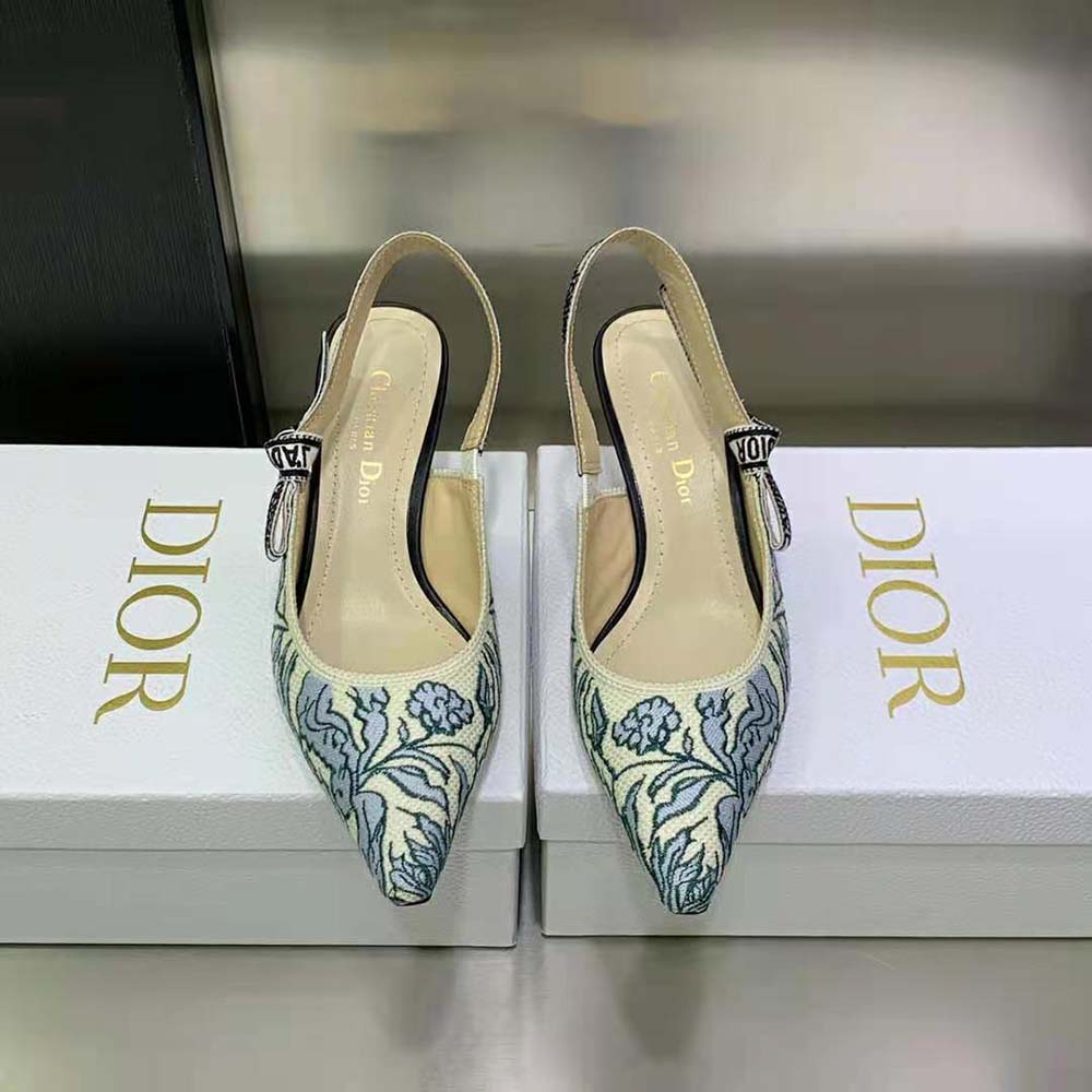 Close-up of J’Adior silver-tone hardware on blue embroidered slingback pump