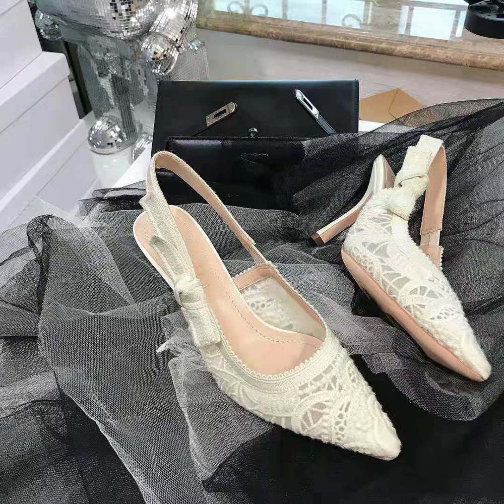 Close-up detail of white macramé embroidery on Dior J’Adior slingback pump
