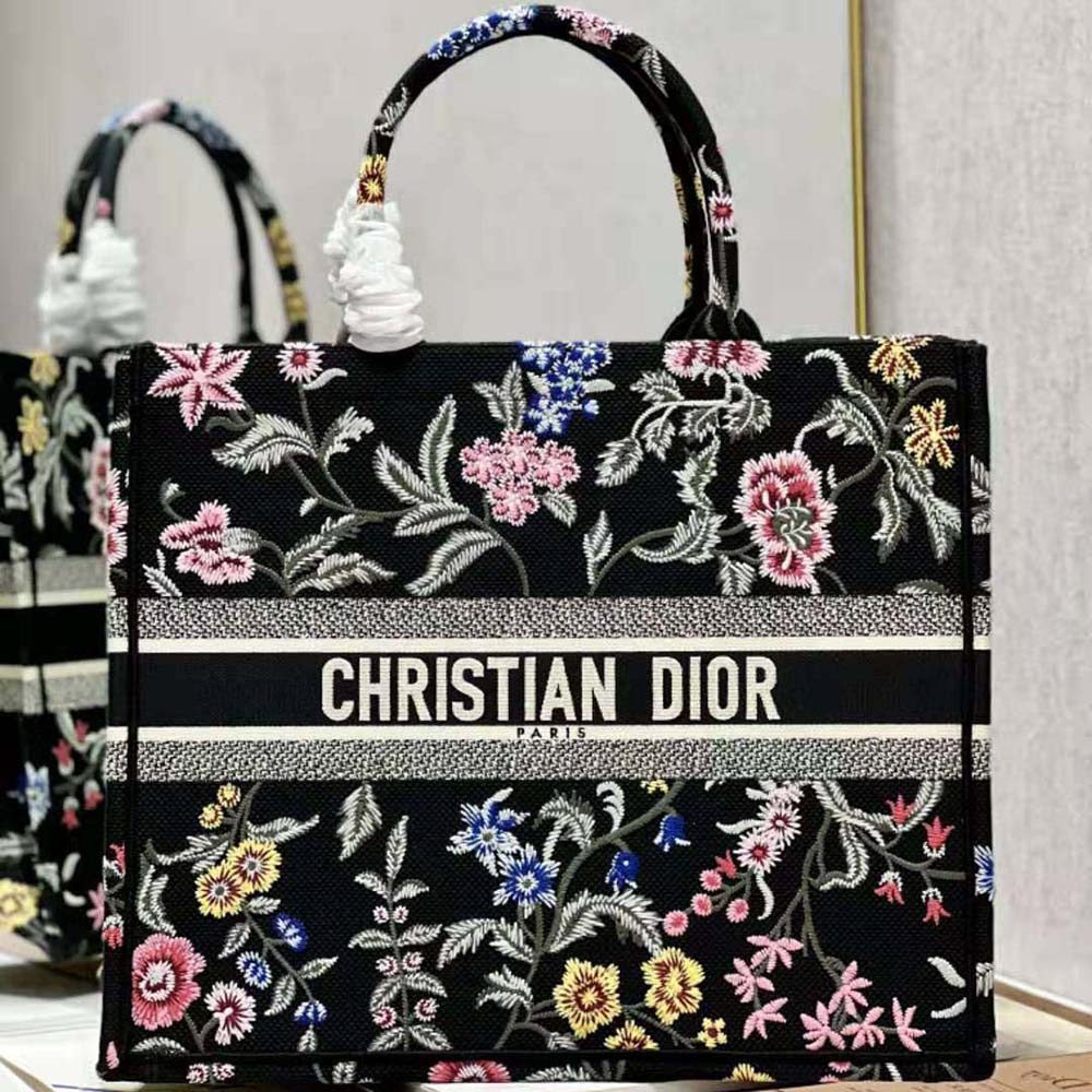 Close-up of multicolor Dior Petites Fleurs embroidery on black canvas tote