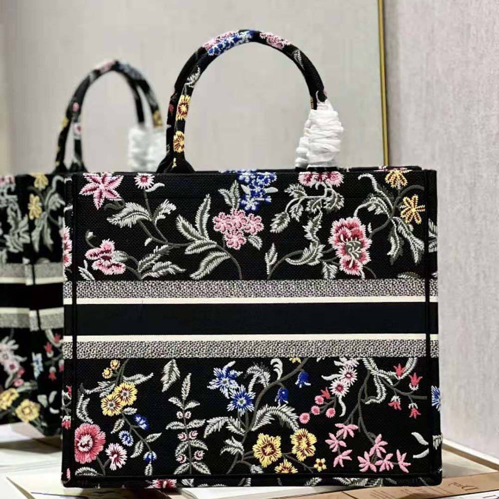 Side angle showing leather accents and gold hardware on Dior Book Tote