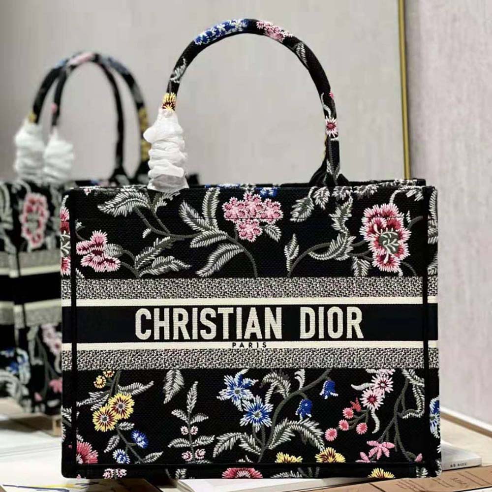 Close-up of multicolor Dior Petites Fleurs embroidery detail on black canvas tote