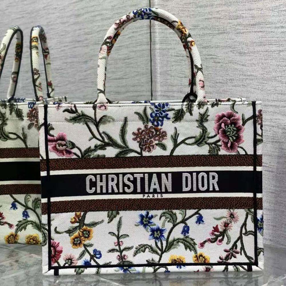 Close-up of multicolor Dior Petites Fleurs embroidery on white canvas tote