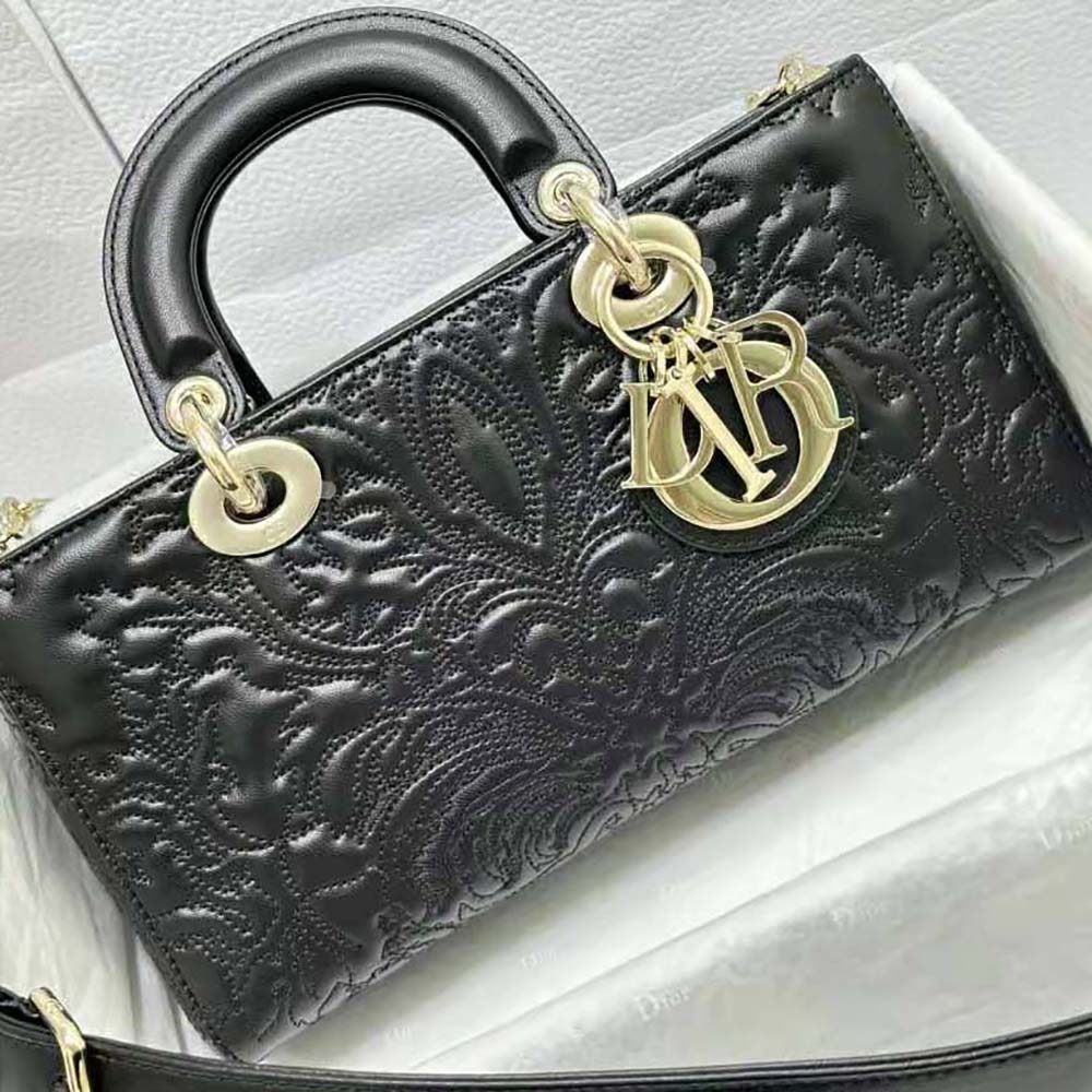 Close-up on gold ornamental motif and quilted lambskin texture