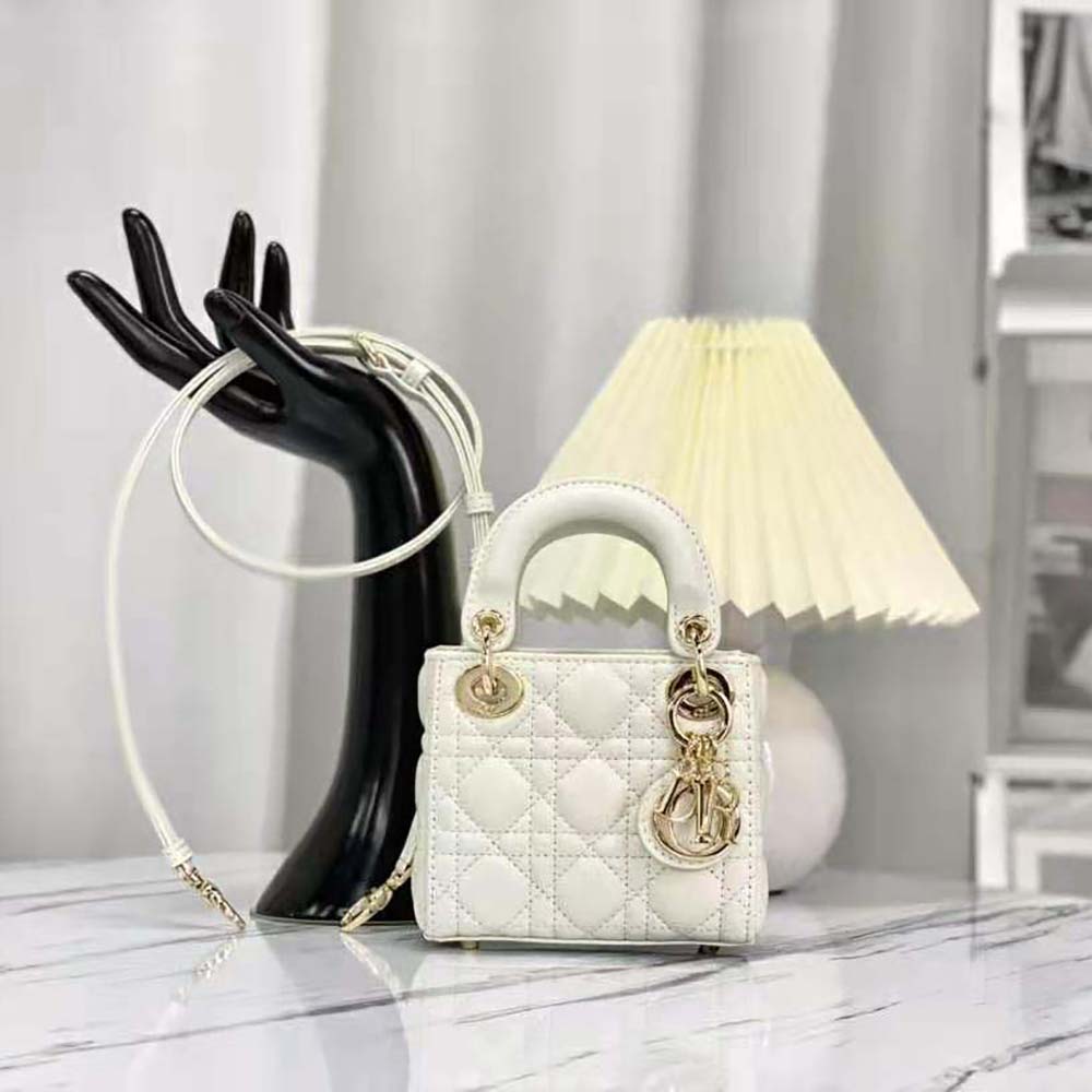 Close-up of white lambskin and gold cannage hardware on Dior bag