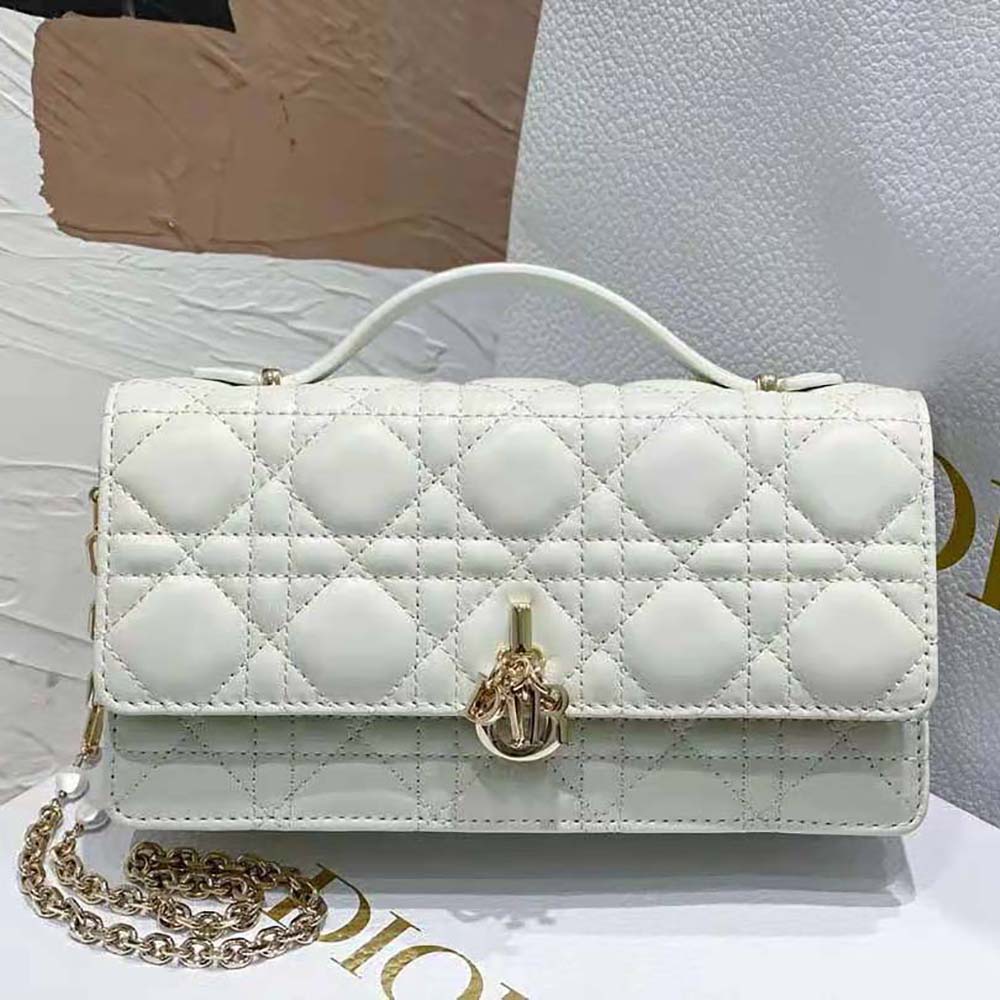 Close-up of silver Dior charm on Mini Miss Dior Bag white lambskin