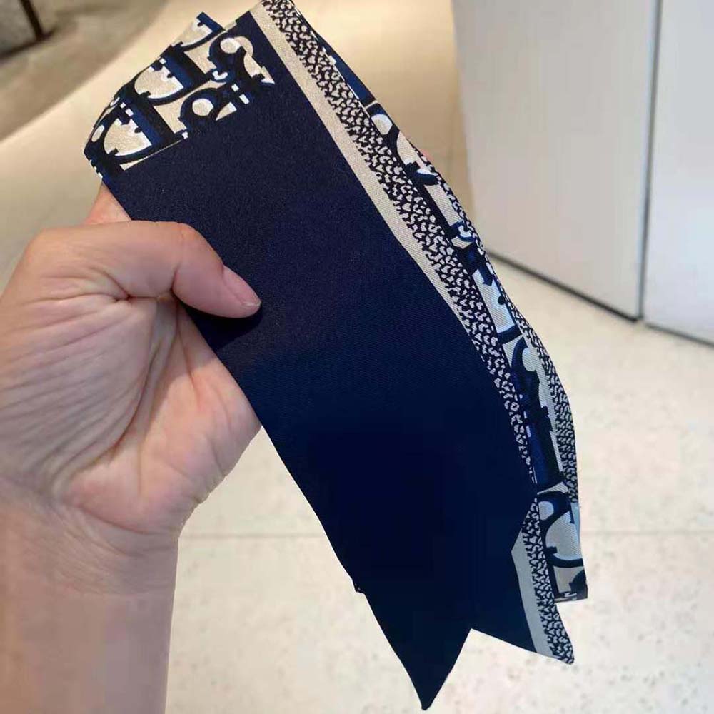 Styled fold of Dior Women Oblique Mitzah Scarf showing silk texture