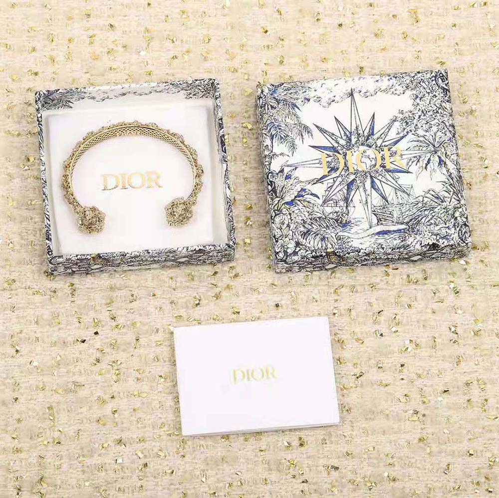 Close-up of gold finish and signature detail on Dior Women Tribales Bangle