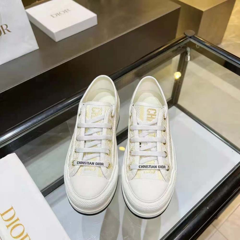 Close-up on gold-tone Dior Oblique embroidery and lace-up closure
