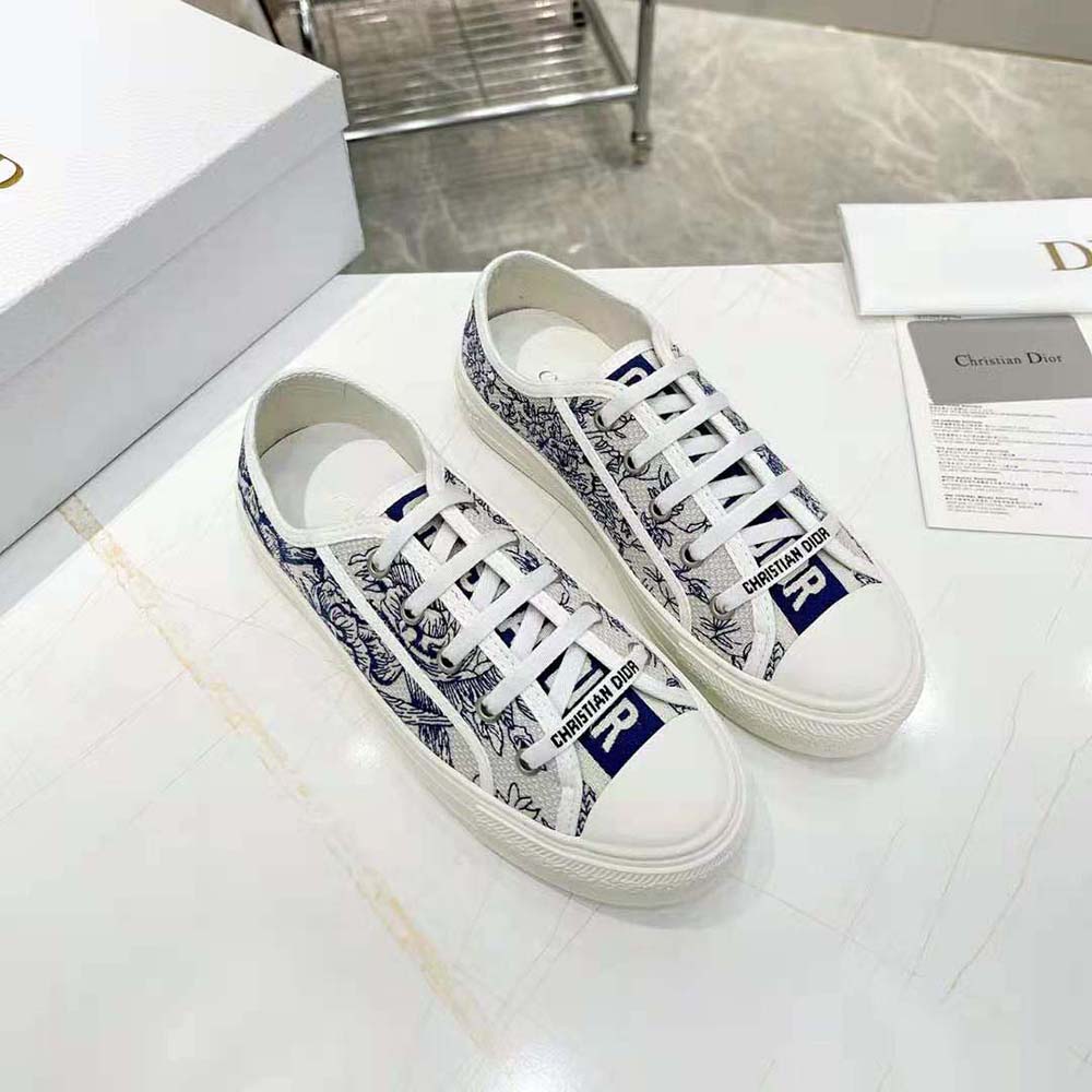 Close-up detail of blue Dior Jardin D’Hiver embroidery on sneaker