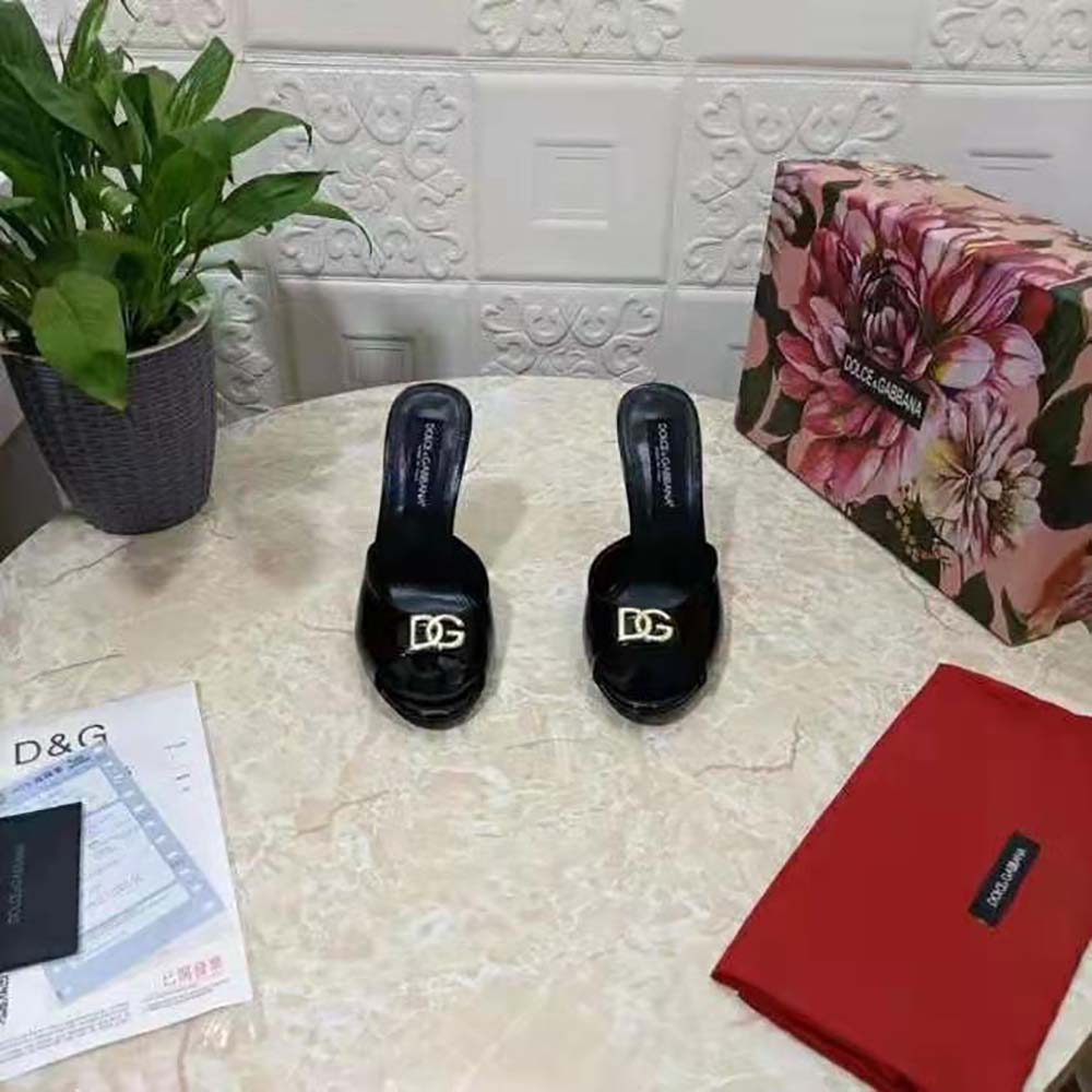 Close-up of DG logo hardware on Dolce Gabbana D&G patent leather mule