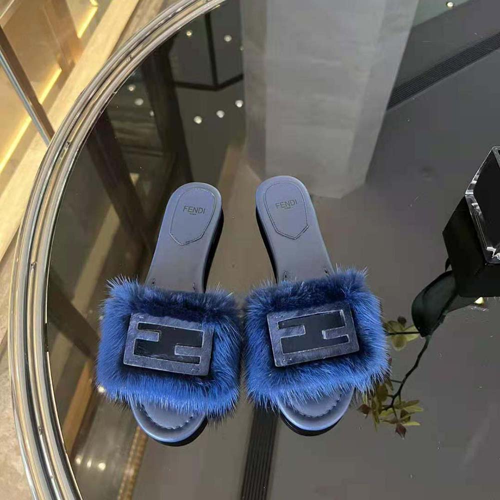 Close-up of gold Fendi hardware on Blue Mink Slides