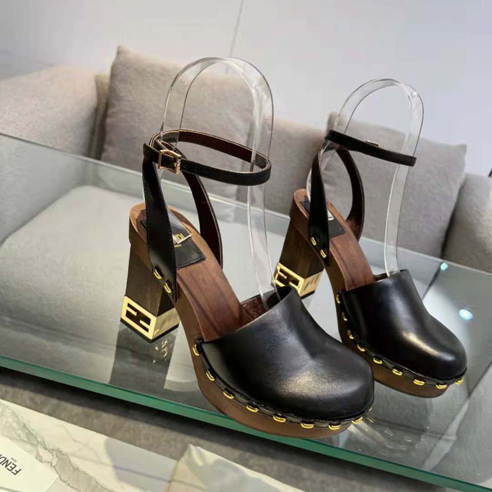 Close-up of signature gold hardware on Fendi Women Baguette Show clogs