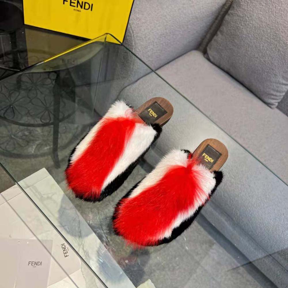 Close-up of red fox fur and Fendi logo hardware on clogs